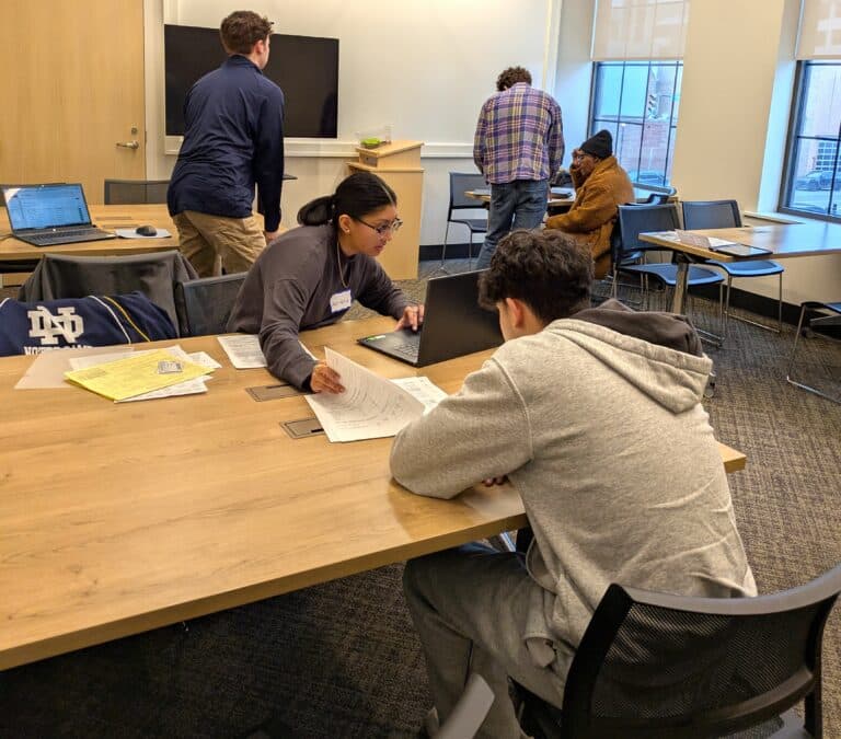 Volunteers helping students with taxes