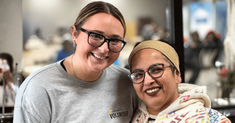 Tax volunteer smiling with tax filer